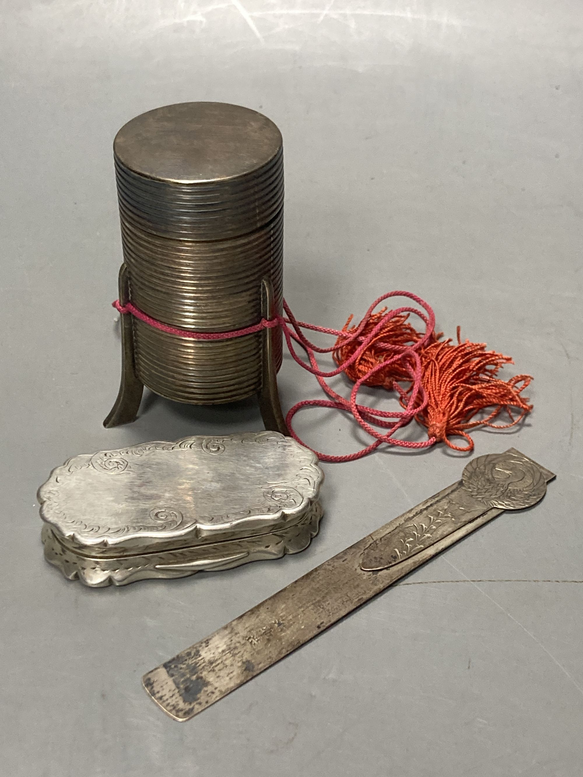 A Victorian silver snuff box(tired) Birmingham, 1846, 67mm, a Japanese white metal bodkin case and bookmark.